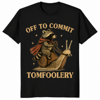 Funny raccoon meme shirt in black with a caped raccoon riding a snail, off to commit tomfoolery