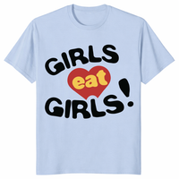 Girls Eat Girls pride shirt in light blue with bold queer humor slogan graphic
