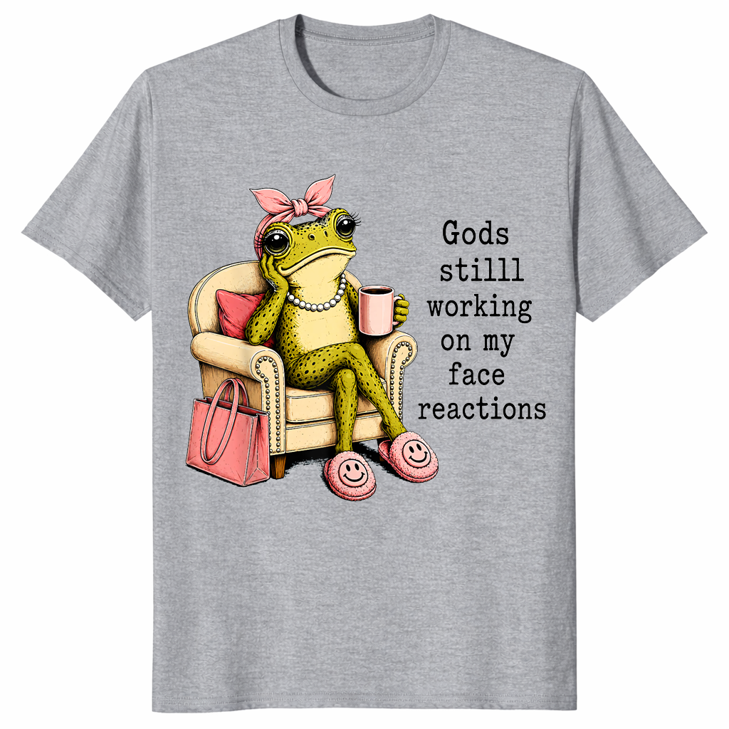 Sport Grey God's Still Working On My Face shirt with an unimpressed frog holding coffee