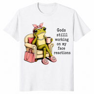 White God's Still Working On My Face shirt with an unimpressed frog holding coffee